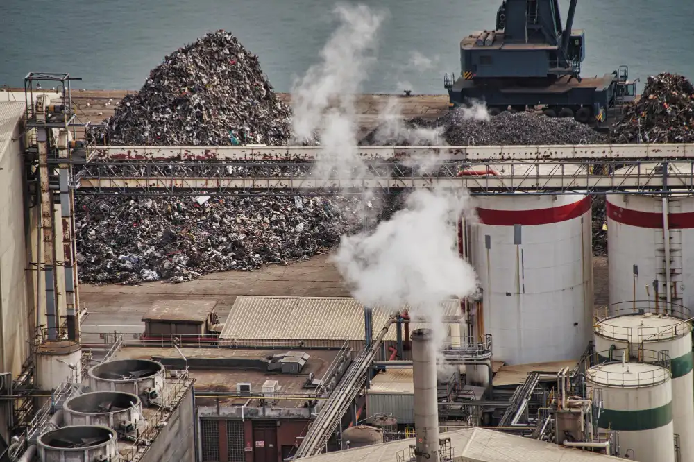 Industrial scrap metal recycling facility with large piles of metal ready for processing, highlighting how responsible recycling helps reduce waste and conserve resources for future generations.
