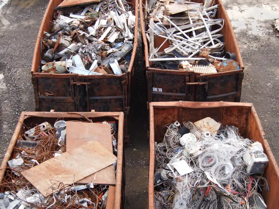 Sorted scrap metal bins containing copper wire, aluminium, steel, and mixed metals at a recycling yard in Adelaide.